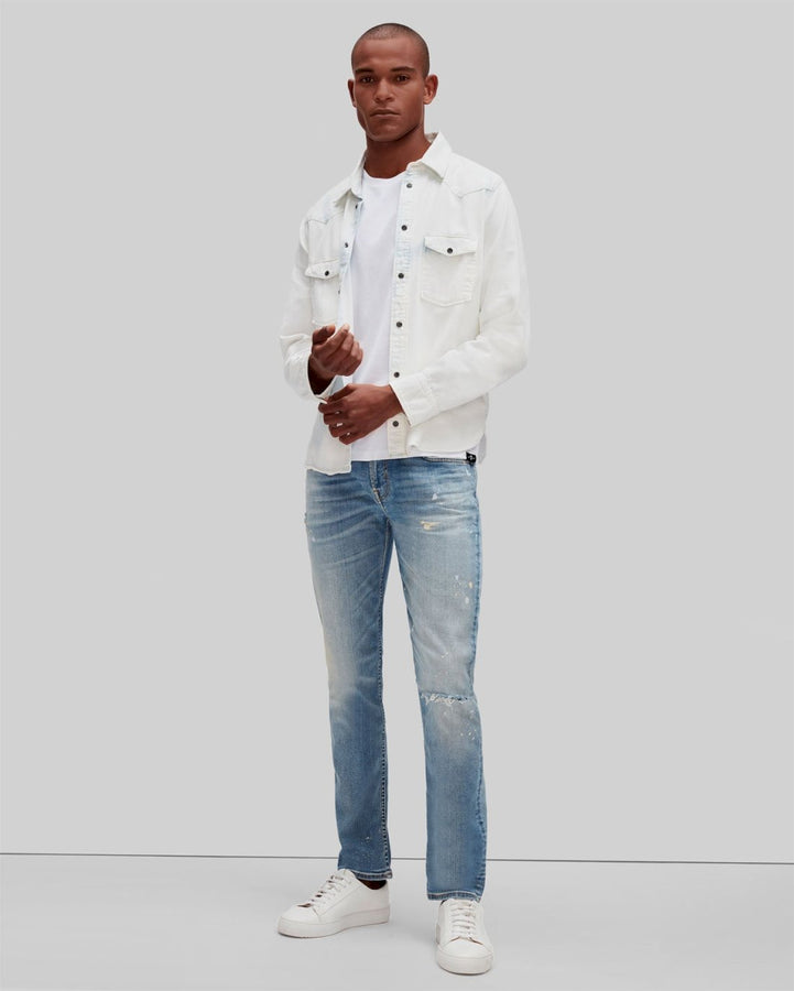 Man wearing a denim overshirt, white T-shirt and white pants with